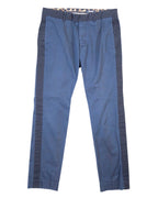 A pair of dark blue trousers with a subtle leopard pattern on the sides, displayed flat on a white background. Roberto Cavalli dark blue trousers with a subtle leopard print and contrast side stripes, straight-leg cut with belt loops, side pockets and a zip fly. Smooth woven fabric with a clean finish; vintage designer piece, rare and unique.