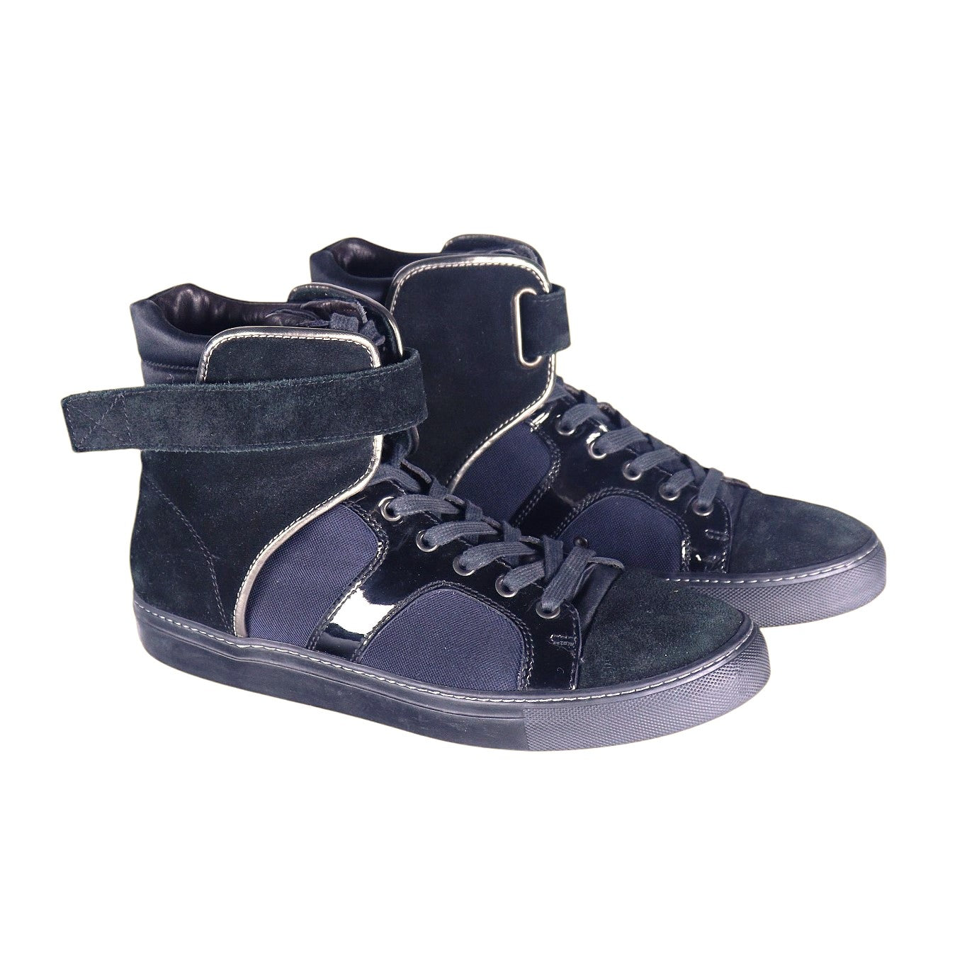 A pair of black high-top sneakers with velcro straps and lace-up closure. Lanvin men’s navy high-top sneakers with suede and patent-leather panels, hook-and-loop ankle strap, lace-up front, and rubber cupsole.