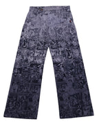 Vintage 1990s Jean Paul Gaultier monochrome comic-strip print trousers/pants in black and grey, soft woven fabric with a mid-rise straight leg, flat waistband with belt loops and front pockets. Pop-art, punk/anarchy graphic vibe with “safe sex forever” panels; luxury designer, rare and unique, laid flat on white.