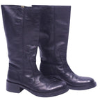 A pair of black tall leather boots with a low heel and no visible brand marking. Roberto Cavalli black tall leather boots with round toe, pull-on shaft, subtle logo stamp, and sturdy block heel.