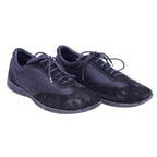 A pair of black suede Versus Versace casual shoes with lace-up closure. Versus Versace black low-top sneakers with suede overlays and mesh panels, lace-up front, round toe and slim rubber sole; minimalist, vintage designer, rare.