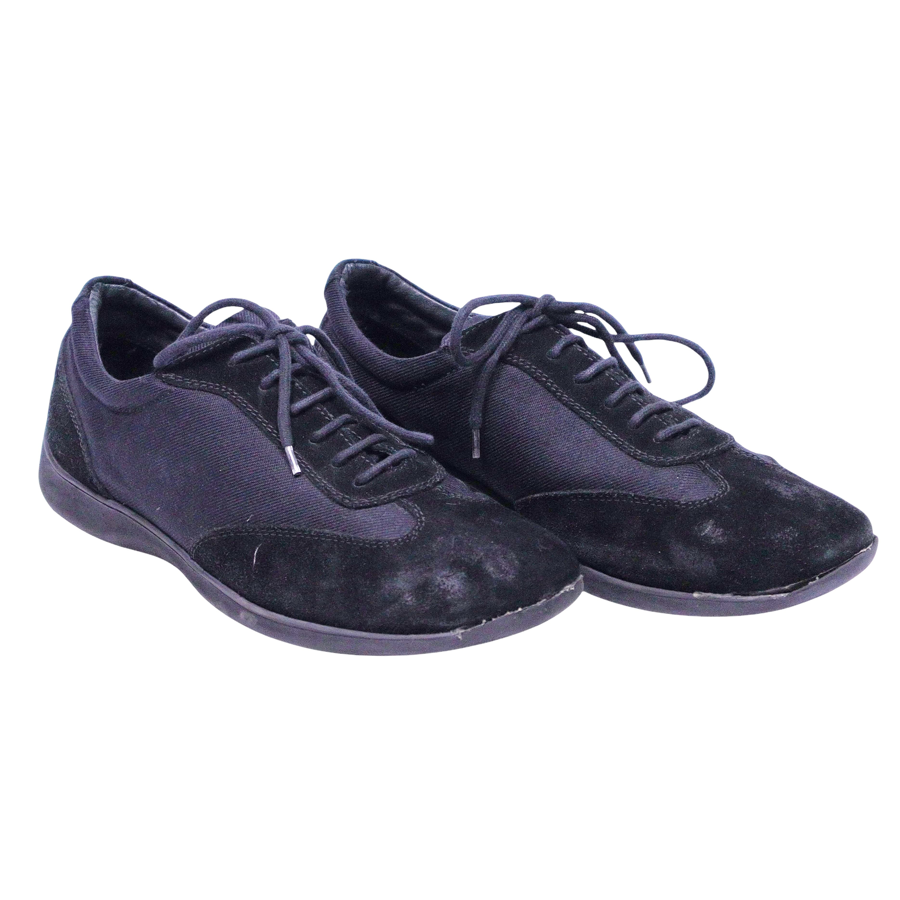 A pair of black suede Versus Versace casual shoes with lace-up closure. Versus Versace black low-top sneakers with suede overlays and mesh panels, lace-up front, round toe and slim rubber sole; minimalist, vintage designer, rare.