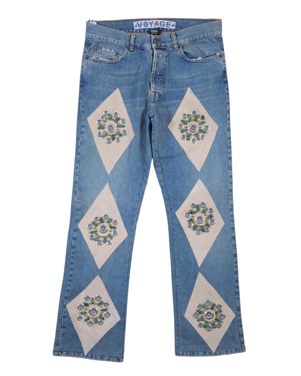 A pair of jeans with stone embroidery design, featuring diamond-shaped patches on the legs. Vintage Voyage Mazzilli Michielsens light-blue jeans/denim trousers with ivory diamond panel appliqués set with stone-like embellishments and studs; mid-rise straight leg, five-pocket button waist with gentle fading—luxury, rare, unique, laid flat on white.