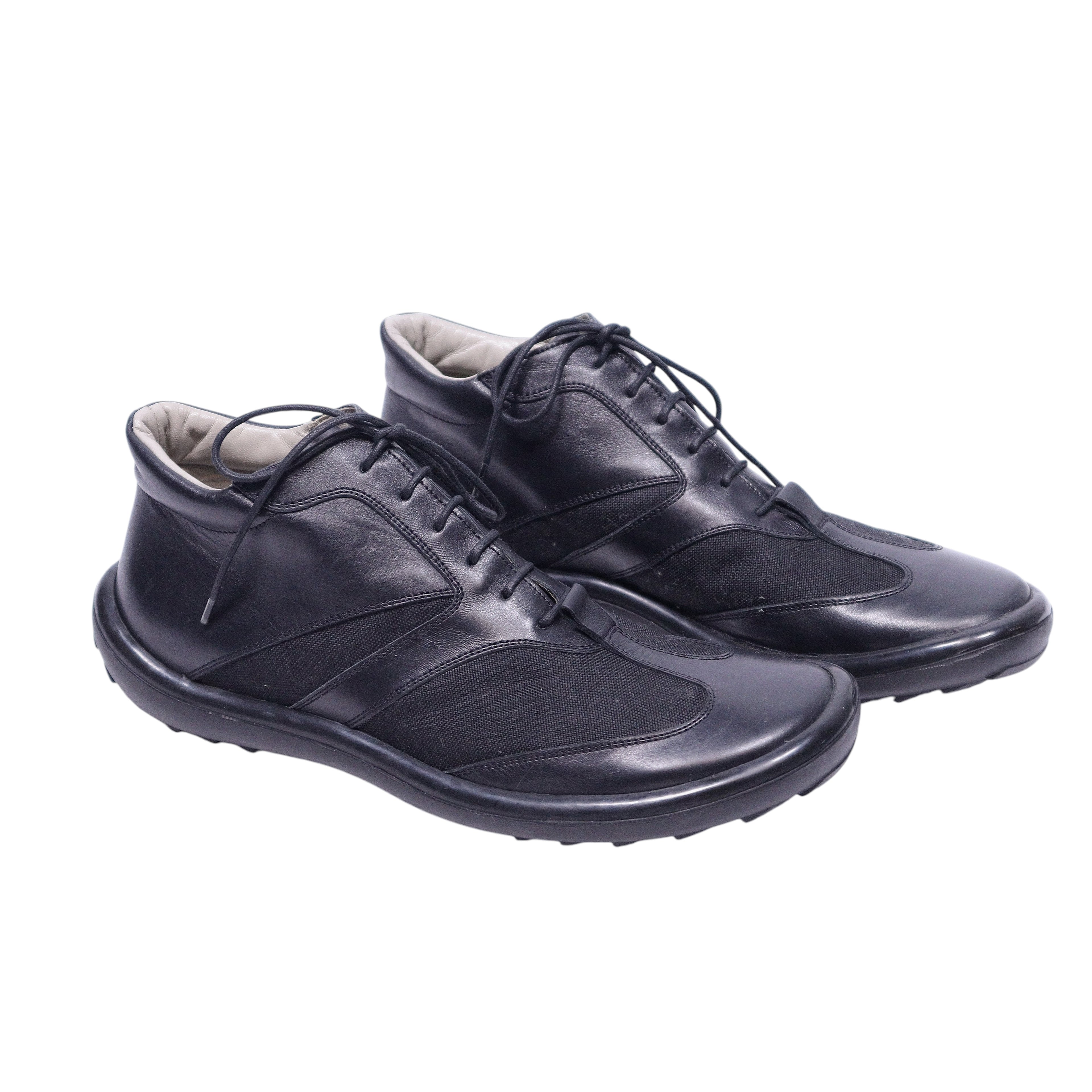 A pair of Gianfranco Ferre black leather shoes with lace-up closure. Black leather low-top sneakers with mesh inserts, lace-up front and rounded toe on a cushioned rubber sole. Gianfranco Ferre minimalist Italian design; vintage and rare.