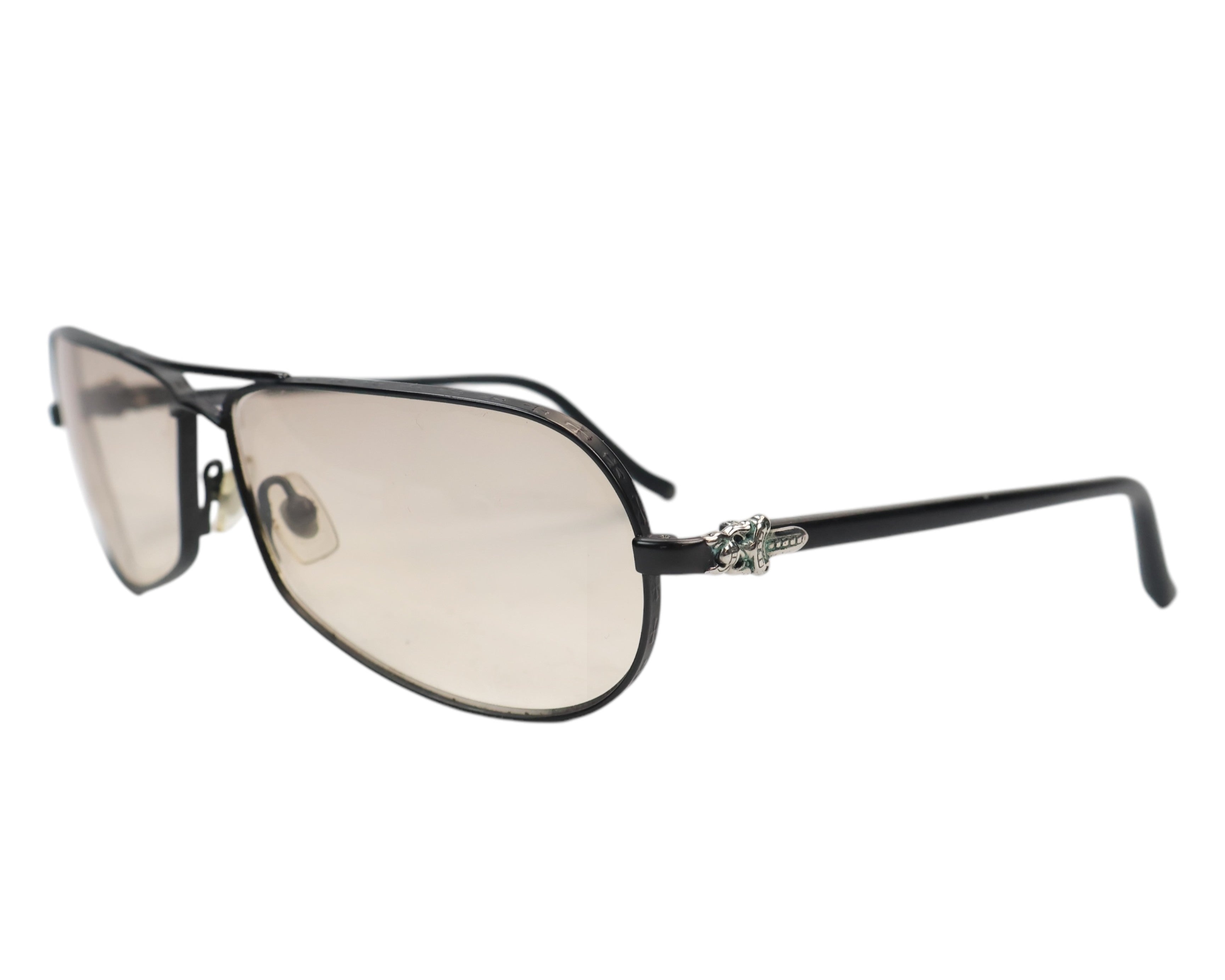 Chrome Hearts “RED” aviator sunglasses; black/gunmetal semi-rim frame with light-brown gradient lenses and adjustable nose pads; signature sterling-silver dagger hinge with green enamel, slim temples; unisex shades for driving, streetwear, rock style; American LA luxury label, eyewear handmade in Japan, cult/limited piece.