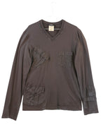 Brown long-sleeve shirt with pockets on a white background. Dolce & Gabbana brown/chocolate cotton long-sleeve T-shirt; V-neck, multiple flat/cargo patch pockets at chest, hip and sleeve with flap + button details, ribbed collar, tonal stitching; relaxed modern fit, unisex; great for denim, cargos, layering; utility/military/Y2K/minimal; Italian luxury house heritage.