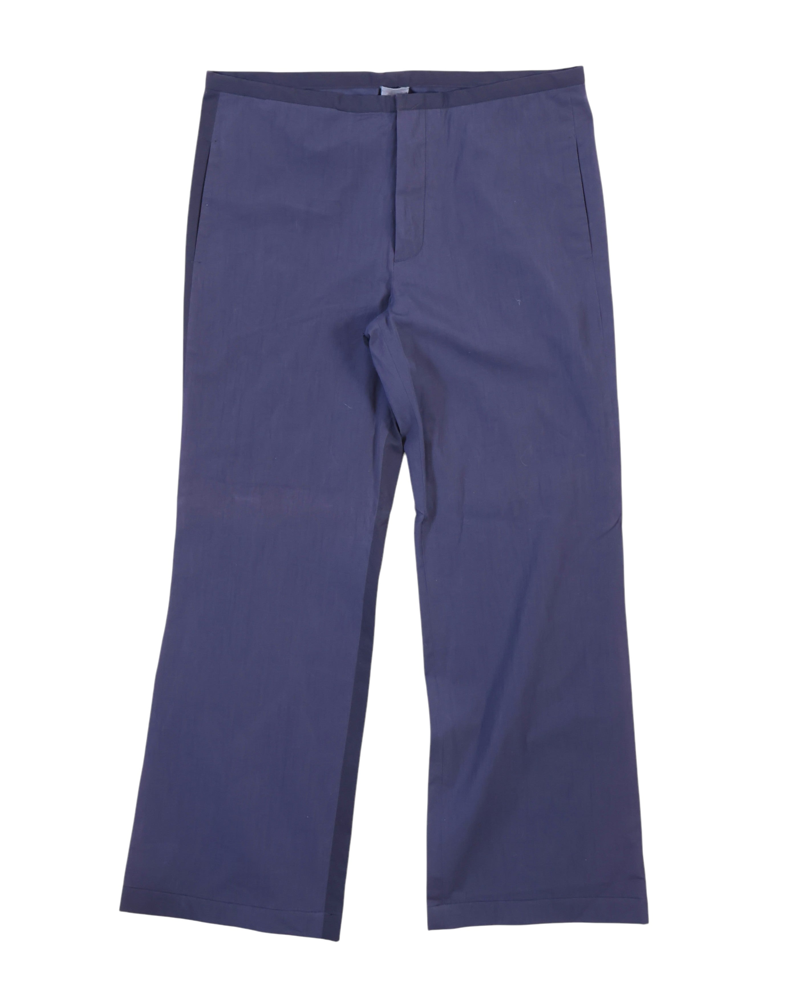 Minimalist two-tone navy trousers with a subtle darker side panel, straight-leg cut and smooth woven fabric; clean waistband, hidden front closure and side pockets—designer, second-hand, rare.