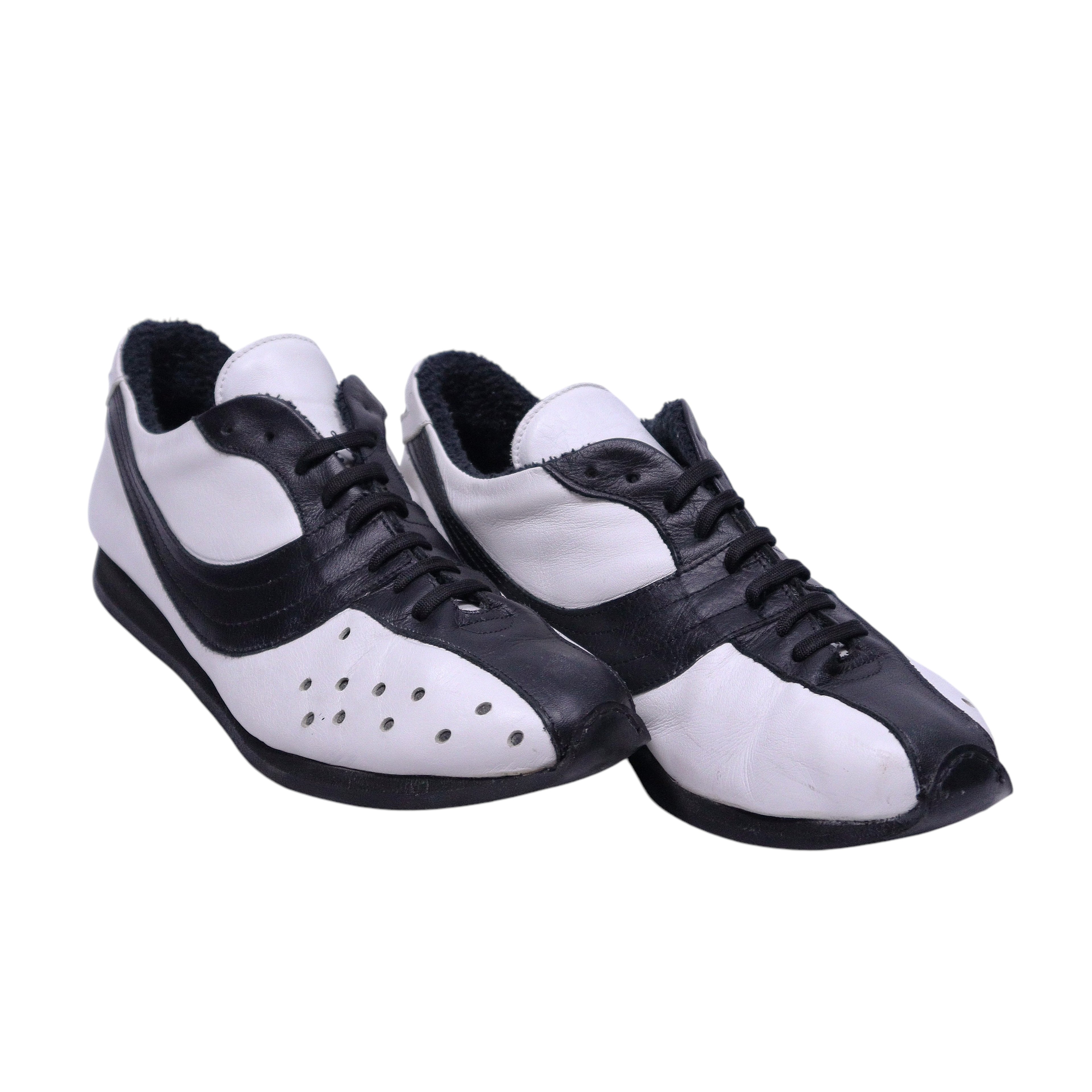 A pair of Dolce Gabbana black and white leather shoes with lace-up closure. Dolce & Gabbana low-top lace-up sneakers in black and white leather with contrast panels, perforated toe detail and a slim rubber sole. Retro racing-inspired, Italian designer pair; vintage and rare.