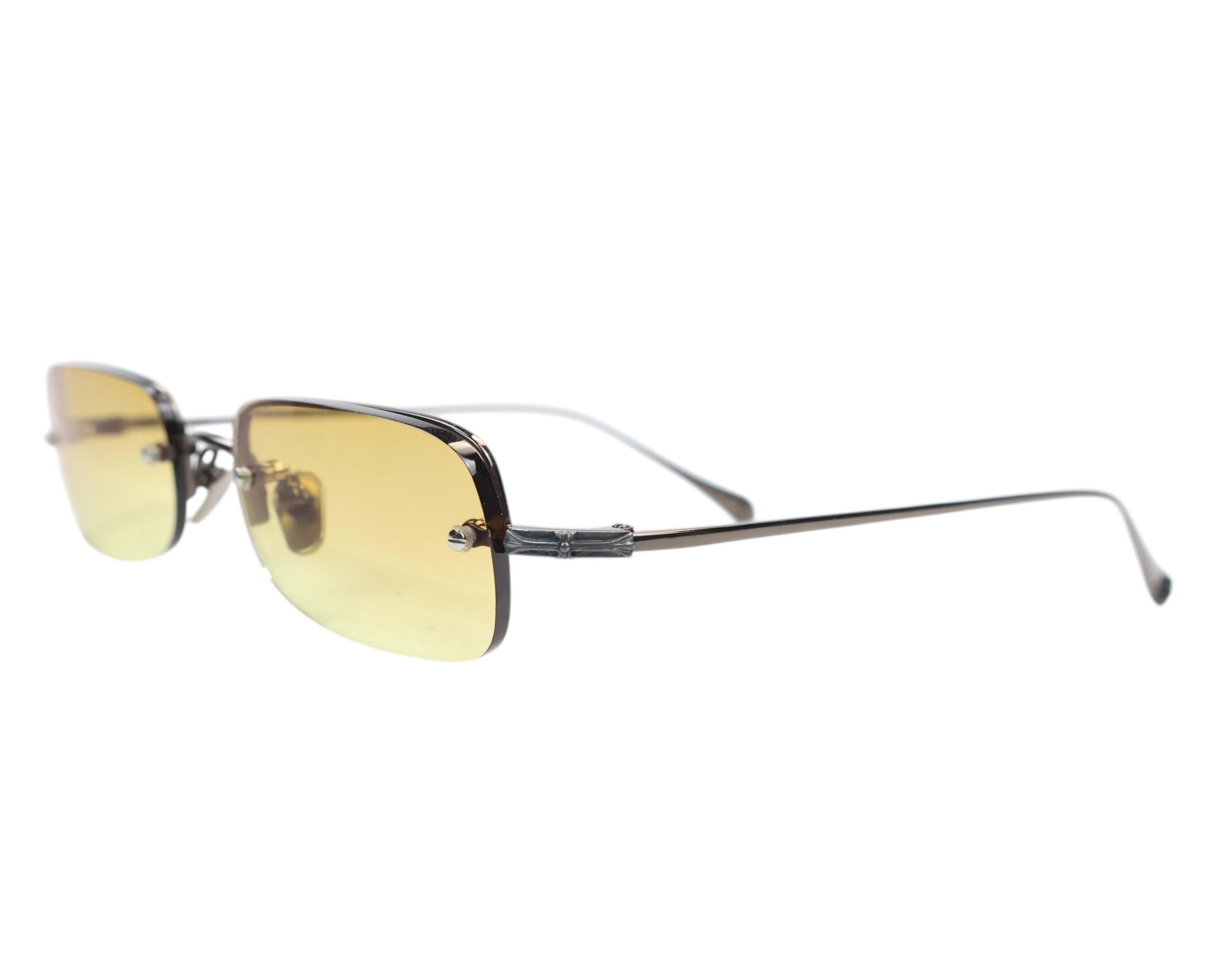 Chrome Hearts titanium sunglasses / shades; semi-rimless rectangular frame in gunmetal titanium with yellow gradient lenses; adjustable nose pads, screw-set lenses; signature sterling-silver dagger temple motif (brand hallmark); ultra-light, hypoallergenic, durable; unisex driving/streetwear/rock eyewear; LA luxury label, eyewear handmade in Japan; rare, cult piece.