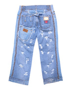 Vintage Dolce & Gabbana Silver Label light-wash denim jeans/denim trousers, back view, heavily distressed with shredded rips, raw frayed hems and a straight, slightly cropped leg. Contrast side stitching, multiple back pockets including an angled oversized pocket with leather logo tab, plus a Union Jack patch—unique luxury designer piece laid flat on white.