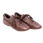 A pair of brown Dolce Gabbana leather sneakers with lace-up closure. Dolce & Gabbana brown leather low-top sneakers with textile/mesh panels, lace-up vamp and slim rubber sole. Sleek retro trainer with rounded toe; vintage, Italian, rare.