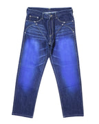 Vintage Issey Miyake blue jeans/denim trousers with V-seamed front, vivid blue thigh fades, and gold-tone contrast stitching with riveted pockets. Mid-rise straight-leg, five-pocket button waist; luxury, rare and unique, laid flat on white.
