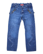 A pair of blue denim jeans with a subtle scratch design, displayed against a white background. Medium blue denim jeans with straight legs and subtle scratch-like designs on both legs, finished with multiple belt straps and metal D-rings plus a button fly; vintage designer, rare.