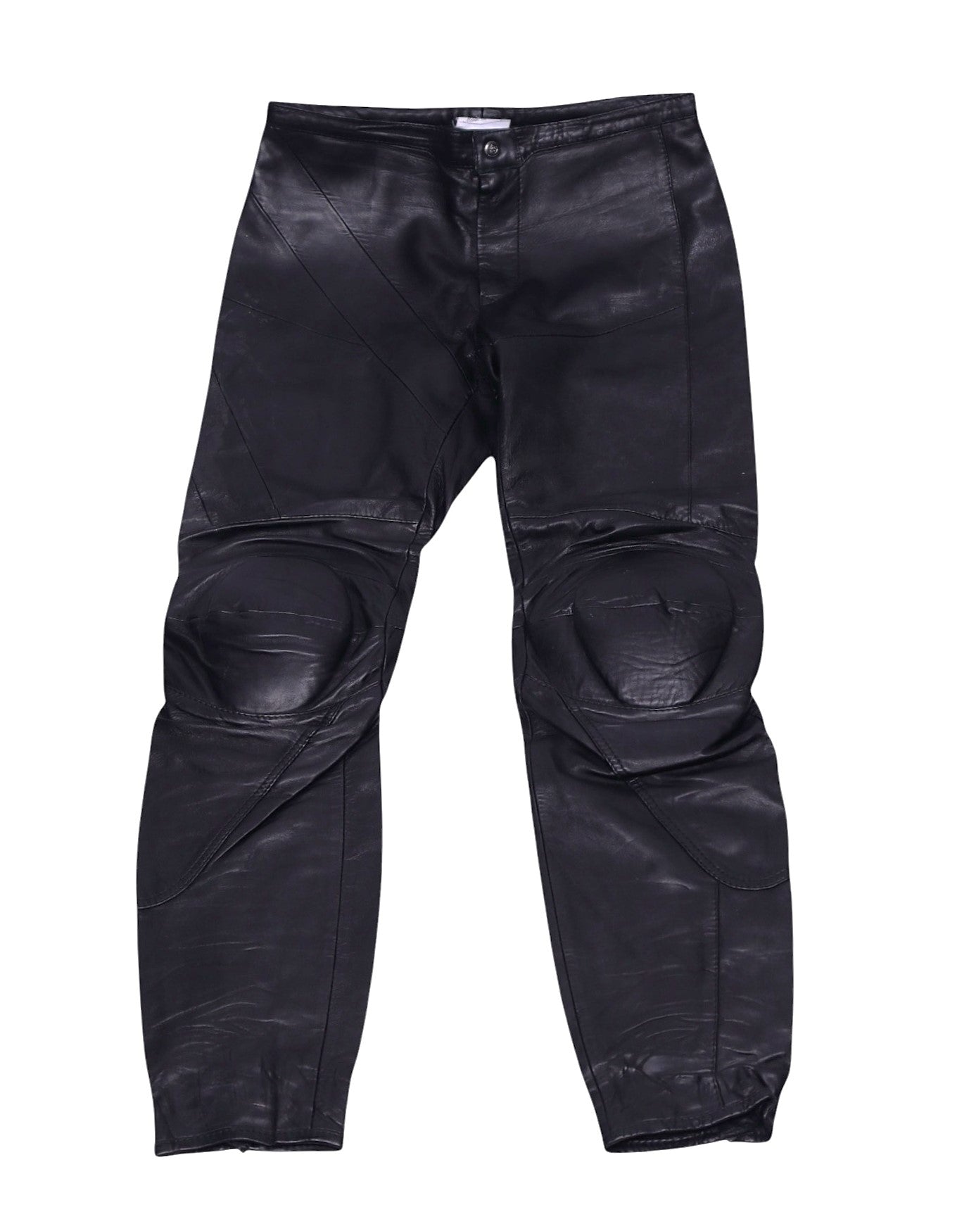 Vintage Gianfranco Ferré black leather moto pants/trousers with protective padded knees, articulated paneled seams and a slim tapered leg; mid-rise button waist with light patina, rare luxury piece laid flat on white.