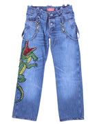 A pair of blue jeans with a crocodile pattern and rhinestone embellishments. Vintage Voyage Mazzilli Michielsens blue jeans/denim trousers with a large crystal-rhinestone crocodile/lizard motif down the leg, red contrast stitching, and a waistband with strap-and ring details. Mid-rise straight leg with classic pockets and button fly; luxury designer, rare and unique, laid flat on white.