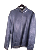 A Bill Tornade leather pullover with wool lining, displayed on a hanger, predominantly dark colored with a textured surface. Vintage Bill Tornade French designer shearling pullover—steel-grey/charcoal genuine sheepskin leather with plush wool/fleece lining; mock-neck/stand collar, raw-edge exposed shearling at cuffs and hem, clean panel seams; relaxed over-the-head anorak/overshirt silhouette, cozy winter-ready insulated outerwear; Paris fashion house heritage; unisex statement layer.