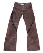 A pair of brown leather pants with lace-up details on the side. Vintage Voyage Mazzilli Michielsens brown leather trousers/pants with dramatic lace-up sides, oversized O-ring belt and flap cargo pockets near the hems; straight-to-flare leg with clean finish. Unique luxury piece, rare and statement, laid flat on a white background.