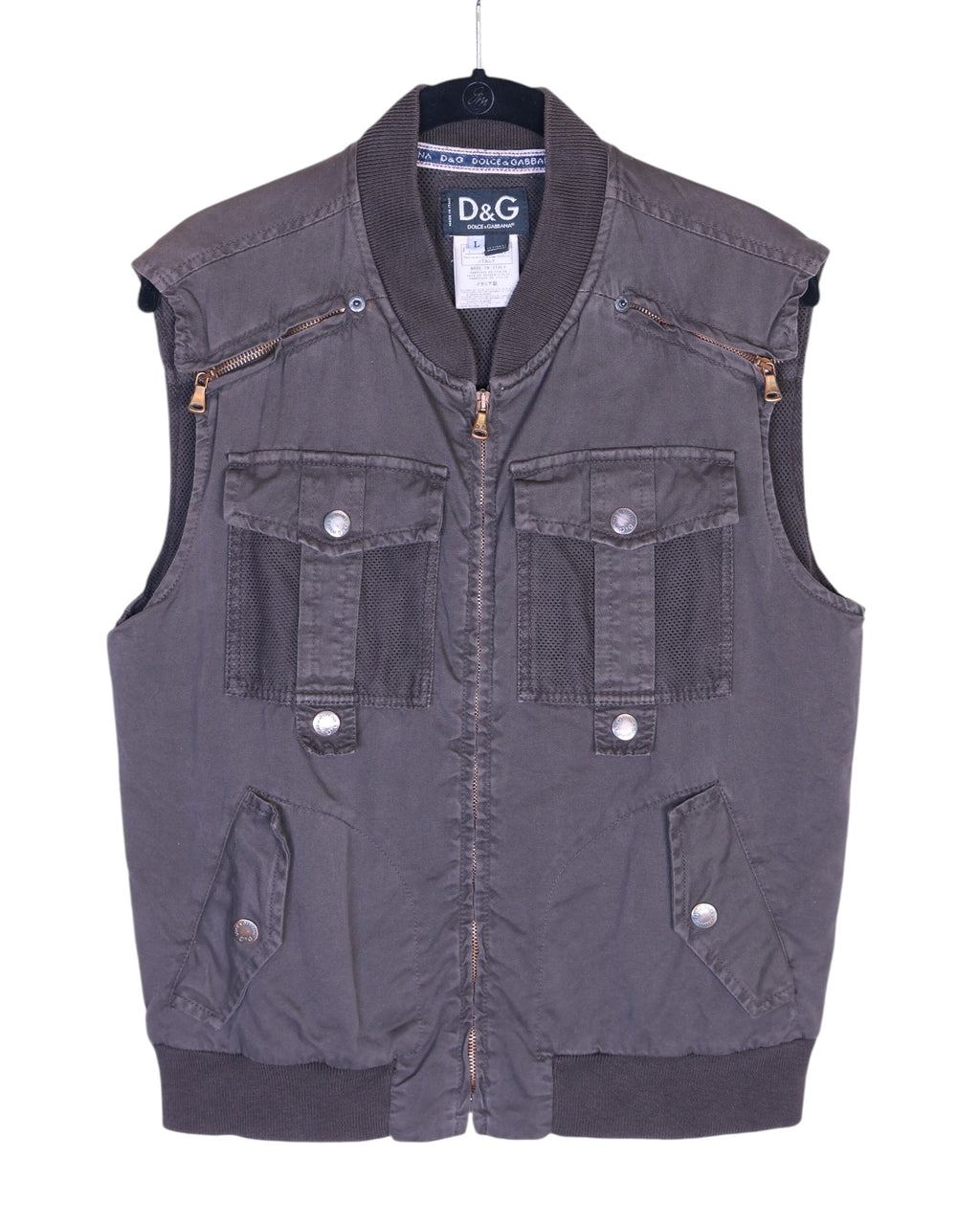Dolce & Gabbana (D&G) 2003 utility vest / gilet / sleeveless jacket in charcoal grey—zip-front, ribbed bomber collar and hem, snap-flap cargo pockets, mesh pocket panels, chest zip pockets, technical nylon-cotton twill, sport/techwear and workwear vibe, Y2K street style layering piece. Italian luxury label known for Milan fashion heritage and sharp tailoring; unisex layer over tees, hoodies or shirts.