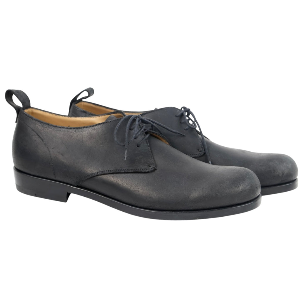 Jil Sander black matte leather derby shoes—minimalist lace-up dress shoes with rounded toe, rear pull tabs, and low stacked heel (men’s).