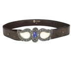 A brown leather belt with a paisley-shaped stone buckle featuring silver and blue colors. Roberto Cavalli dark brown leather belt / waist strap; ornate silver-tone buckle in paisley shapes with cream stone inlays and a central blue cabochon; engraved floral detailing; unisex; great with jeans, tailoring or boho fits; style tags: western, rock, Y2K, statement; Italian luxury house from Florence, artisanal craft; rare vintage.