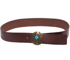 A brown leather belt with a copper buckle featuring a blue crystal in the center. Roberto Cavalli brown/chocolate/tan leather belt / waist strap; round copper/brass concho buckle with engraved Western motif and turquoise-blue stone inlay; smooth one-piece strap; unisex; great with jeans, tailoring or dresses; style tags: western, boho, rock, statement; Italian luxury house from Florence, artisanal craft; vintage, rare piece.